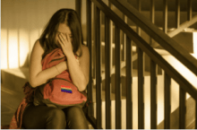 Sad girl crying on set of stairs 