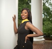 woman posing beside a pillar